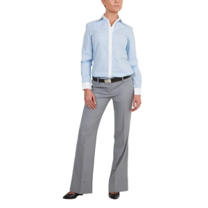 A woman wearing a light blue statement shirt with white cuffs and collar, grey dress pants, a black belt, and black shoes stands against a white background. Her head is slightly turned, and her arms rest by her sides.