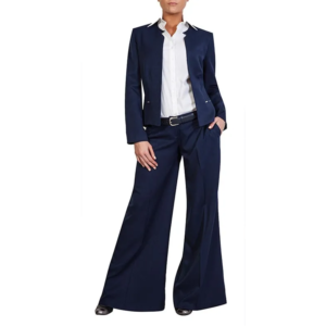 Stylish person in a tailored navy cropped jacket, white shirt, wide-leg pants, and dark belt.