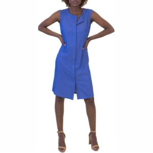 Woman posing, hands on hips, in a stylish blue sleeveless knee-length dress and tan high-heeled sandals.