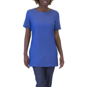 Professional woman smiling, wearing a royal blue short-sleeved tunic and dark blue pants.