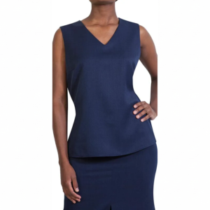 Woman in navy blue V-neck sleeveless top and matching skirt set, left hand on hip, right arm down.