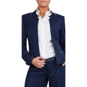 Navy blue collarless blazer with zipper pockets, white shirt, matching trousers, and dark belt.