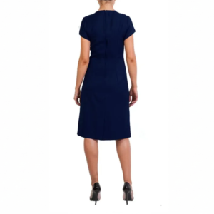 Woman models a navy blue short-sleeved knee-length dress and black high heels, seen from behind.