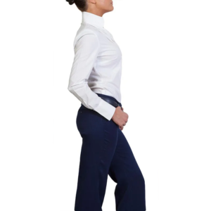 A woman in a crisp Kuma Shirt and dark blue pants stands in profile against a white background.