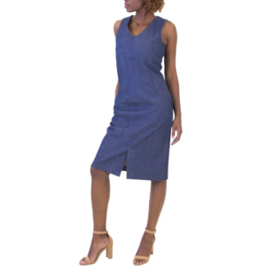 Woman standing in a sleeveless, V-neck, knee-length blue denim dress with a front slit and tan high heels.