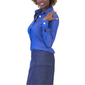 Smiling woman in a blue button-up shirt with white buttons and slit cuff, and a dark blue skirt with pocket.