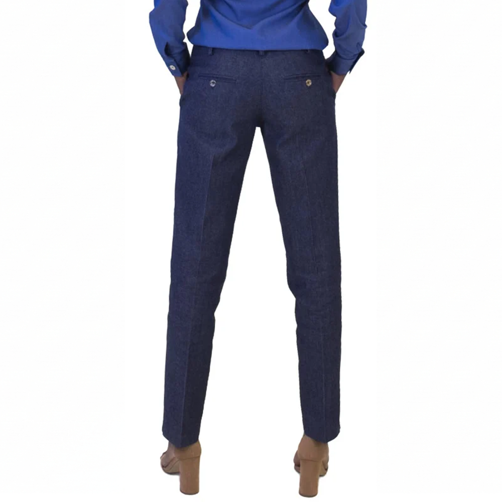 Back view of a person in a casual blue shirt, dark blue pants with back pockets, and tan block-heeled sandals.