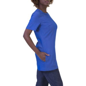 Woman in a blue short-sleeved tunic, left hand casually in pocket, side profile view from chest to upper thighs.