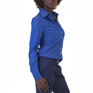 Person in a crisp long-sleeved royal blue collared shirt with light buttons and dark blue trousers, standing in profile.