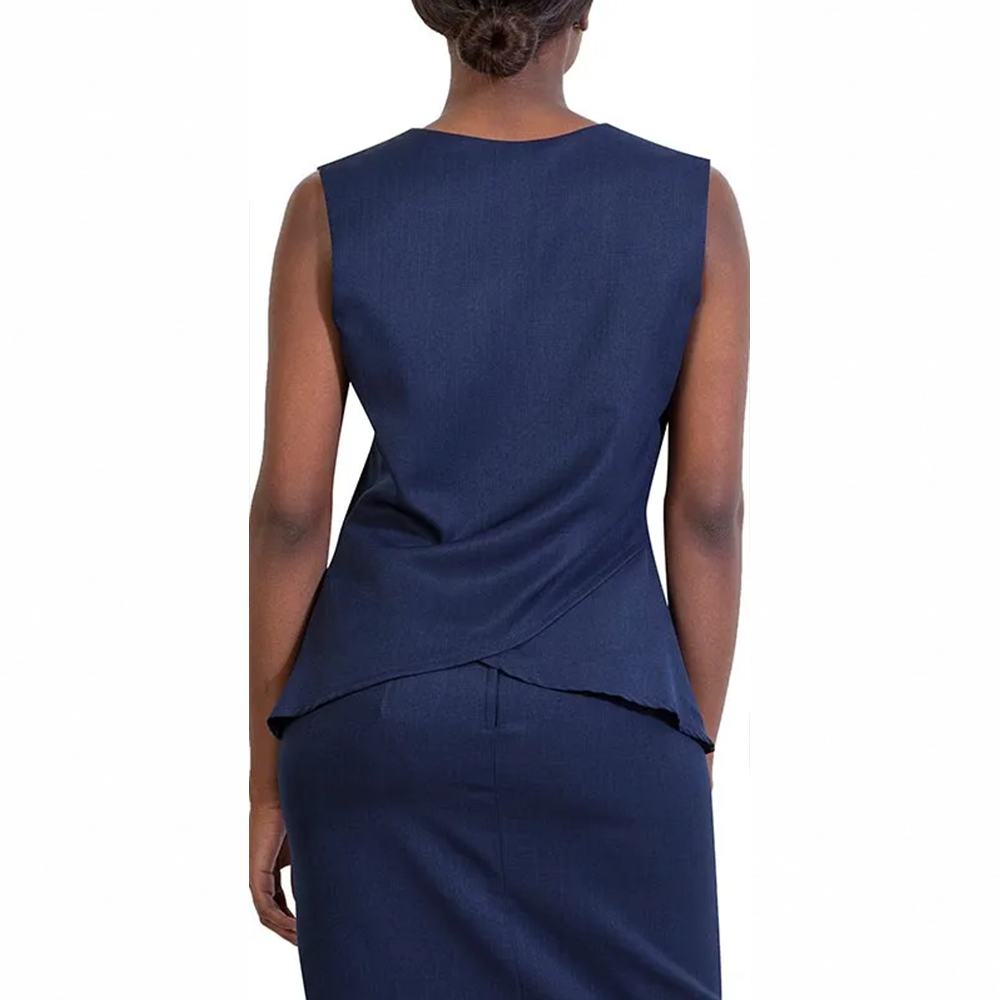 Woman from behind in a dark blue sleeveless top with a layered hem and matching skirt set.