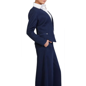 Stylish person, side profile, in navy blue blazer, white collared shirt, wide-leg pants, left hand in pocket.