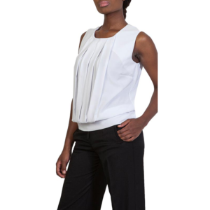 Stylish woman in light gray pleated sleeveless top and black tailored pants, hand in pocket.
