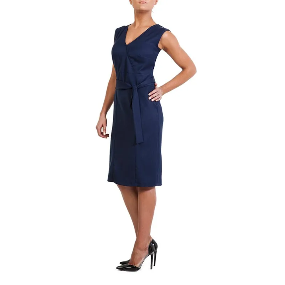 Woman modeling a navy blue sleeveless V-neck wrap dress with a tie belt and black high heels, side view.