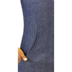 Hand partially inserted into a curved pocket of a blue denim garment.