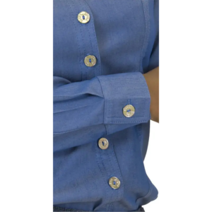 Close-up of a blue chambray shirt with silver snap buttons on the front placket and sleeve cuff.