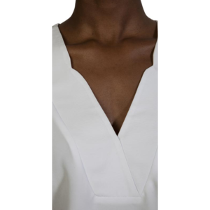Elegant white Zaniah camisole with V-neck design, perfect for stylish casual or dressy wear. Made from high-quality fabric, offering comfort and a sleek look.