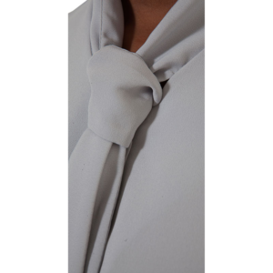 Light grey tie-neck blouse featuring a fabric knot at the collar.