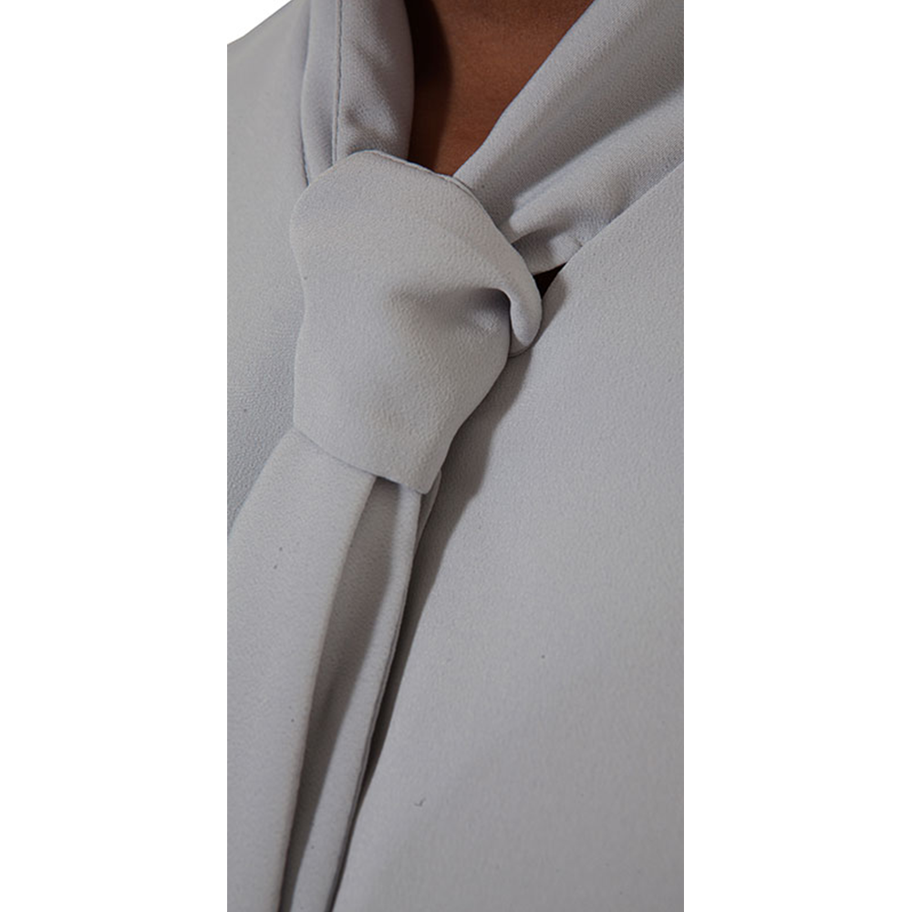Light grey tie-neck blouse featuring a fabric knot at the collar.