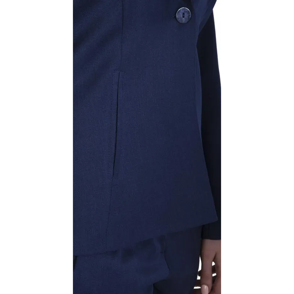 Person in a navy blue single-button blazer and matching trousers, side profile.