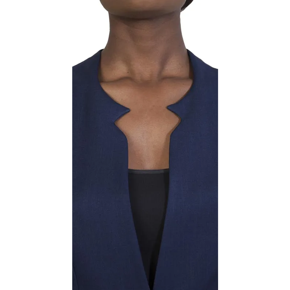 Upper chest in a dark blue blazer with a prominent double-notched lapel, worn open over a black top. Business style.