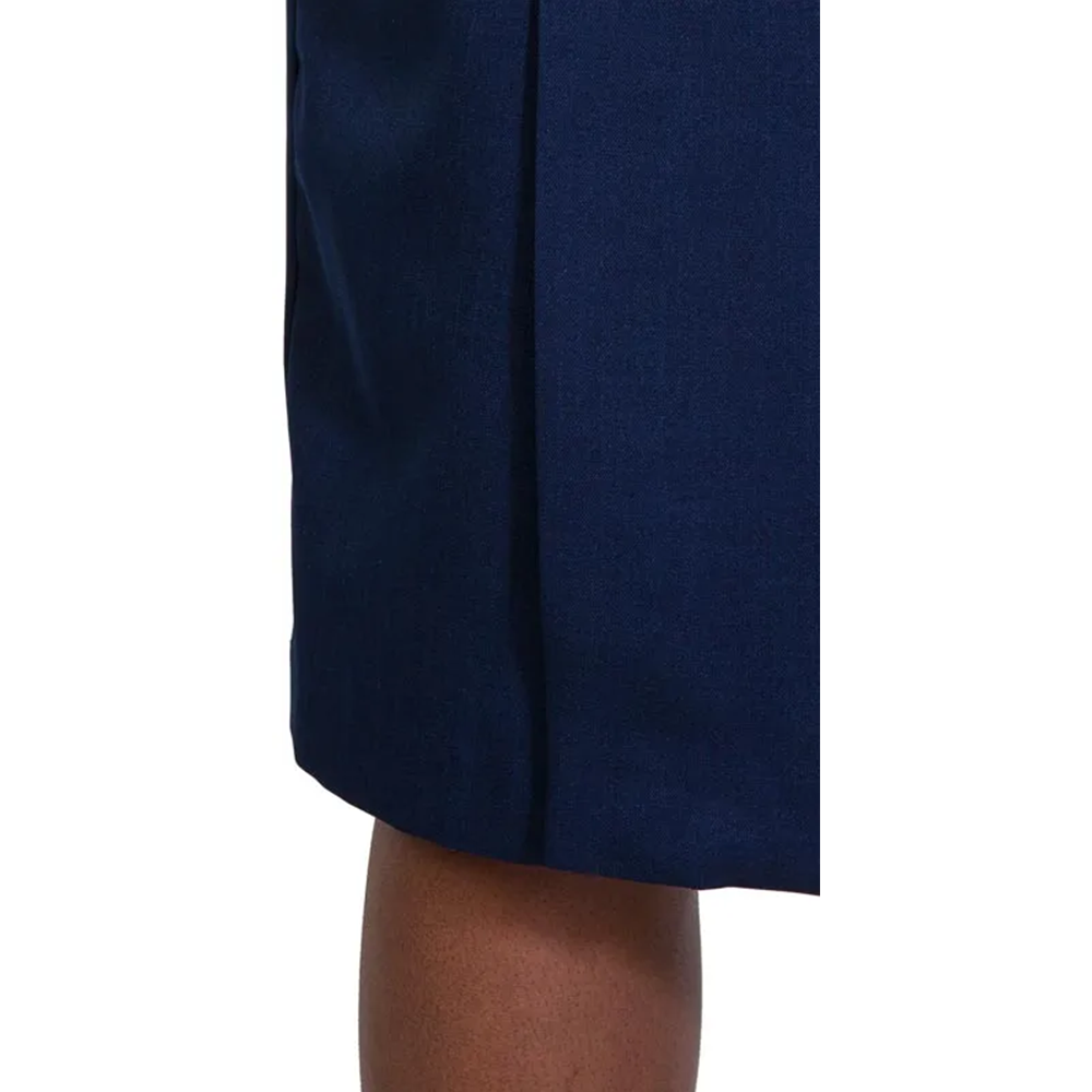 Dark blue accordion pleated hemline above a bare leg with rich, dark skin.