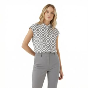 Elegant checkered Vogue blouse with cap sleeves, perfect for stylish casual or office wear. Made from comfortable, high-quality fabric, this versatile top complements various outfits.
